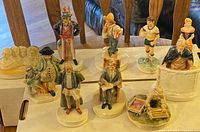Overall view of all 10 Sebastion miniature figurines arranged on a white surface.