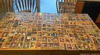 Wide view of many Red Sox player cards spread out on a table showing about 220 cards.