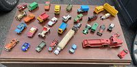 Overview photo of all 34 vintage toy cars and trucks arranged on table