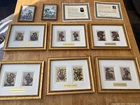 Full view of eight framed prints on table: six gold ornate frames each with two 10 x 8 prints, two smaller frames each with one 4 x 6 print, plus letters of authenticity