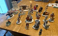 Full collection of 24 Sebastion miniature figurines displayed on table showing varied characters and scenes.