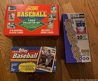 Three unopened baseball card sets in their original factory boxes: 1992 Score Collector Set, 1993 Topps Collection, and 1997 Upper Deck Factory Set