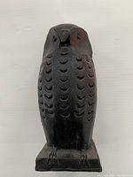 Front view of the artisanal metal owl sculpture showing feather detailing and mounted on square base.