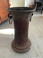 Side view showing the full height and shape of the large antique iron fitting with two rings attached.