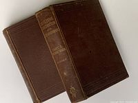 Pair of antique Victorian builder's books side by side showing titles and spines clearly.