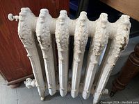 Front view showing six ornate cast iron columns