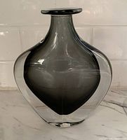 Full front view of the smoky gray Sommerso glass vase with clear outer layer, showing shape and coloration.
