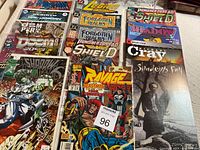 Photo showing full layout of 14 comic books including Spider-Man, Legion, Punisher 2099, Forgotten Realms, Shadow, Ravage, and others