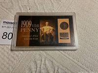 Full view of 1909 VDB Penny encapsulated in protective case with text and image.