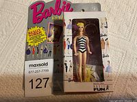 Photo of 1995 Barbie Keychain in original packaging with Barbie illustrations and logo, showing the front of the box and the doll inside.