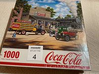 Photo of sealed puzzle box showing vintage Coca-Cola scene with truck, cars, and steam train
