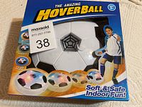 Boxed Amazing Hoverball toy showing front side with product name and colorful LED light illustrations.