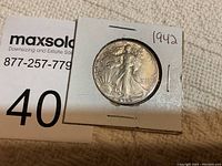 1942 Walking Liberty half dollar coin in protective holder with label showing the year 1942