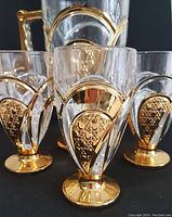 Close-up view of the glasses' gold pineapple motif and trim.