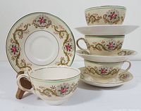 Four Johnson Brothers Pareek tea cups and matching saucers with floral and gold scroll pattern, showing front details and condition.