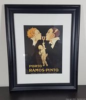 Framed and matted poster displayed on neutral wall showing overall condition and framing details.