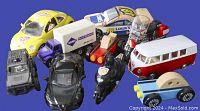 Overview of all toy vehicles in the lot showing variety in sizes, colors, and types including cars, motorcycles, a truck, a bus, and a train engine.