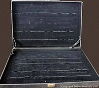 Open view of travel jewelry case showing interior elastic slots for jewelry organization