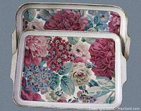 Two rectangular vintage Sezzatini trays stacked, showing floral hand painted design and white border with handles.