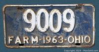 Front view of blue 1963 Ohio farm license plate with white embossed number 9009 and text FARM 1963 OHIO.
