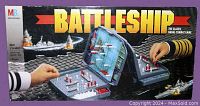 Front of the game box showing Battleship title, naval combat artwork with battleship in background, and depiction of the plastic foldable game board set with pegs and screen divider.