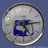 Full view of round Timex quartz wall clock showing clock face with Bob Hope caricature and golf imagery.