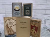 Six early 1900s cookbooks arranged in two rows showing covers and some opened pages.
