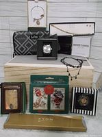Photo showing the assorted boxed jewelry including bracelets, necklaces, earrings, wristwatch, wallet and card sets
