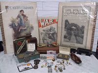 Wide shot showing magazines, boxes with cufflinks, pins, Wheat pennies, and train car model
