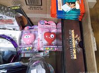 View of various collectible items with Hallmark and Breyer figurines, sealed candy hearts, collectible card packs, and Warhammer Online box