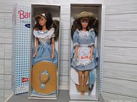 Two Little Debbie Barbie dolls in their original packaging showing the overall presentation including outfits and hats.