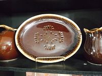 Brown drip glaze oval platter 13 inches with embossed design on the surface
