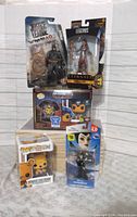 Full lot featuring all boxed figures including DC Batman, Marvel Makkari, two Funko Pop! figures, and Disney Infinity Maleficent