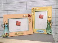 Two Russ Berrie 4x6 picture frames with 3D angel figurines and floral decorations, labeled Happiness and Cherish.