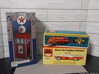 Three original boxed die cast Texaco coin banks: a red Texaco gas pump, a 1939 Dodge Airflow, and a 1957 Ford Ranchero.