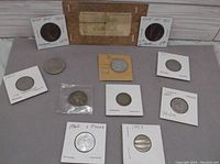 Full display of all coins and one banknote laid out showing dates and inscriptions