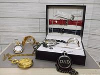 Overview of lot including wristwatches, pocket watches, watch straps, tie clip, and cuff bracelets in a box