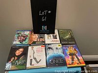 Full view of nine assorted DVDs including Suicide Squad and Mona Lisa Smile with black sign