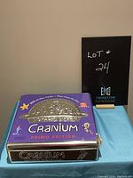 Full front view of the Cranium Primo Edition game tin, showing main design and condition of packaging.