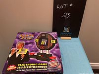 Boxed Family Feud electronic game with digital scoreboard and buzzers.