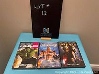 Three DVD cases showing The Incredible Hulk, Fantastic 4, and Iron Man movies.