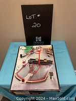 Photo of boxed mini basketball tabletop game showing contents and packaging with LOT #20 sign in background.