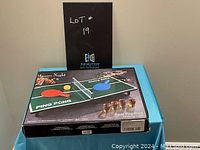 Photo showing the boxed Game Night Table Ping Pong Drinking Game with key components and game branding visible on packaging.