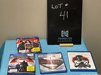 Shows four superhero movies on DVD and Blu-ray: Batman v Superman Ultimate Edition, Man of Steel, Captain America, Wolverine.