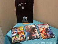 Photo of the lot showing three DVD cases including a 4-film Superman collection, Man of Steel movie, and Supergirl Season 1 DVD.