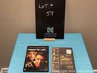 Photo showing both DVD cases together, The Godfather 3-Movie Collection still sealed, Proof of Life DVD opened