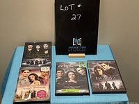 Five Twilight series DVDs displayed on a table including Twilight, Eclipse, Breaking Dawn 1 & 2, and Breaking Dawn: The Twilight Revelation.