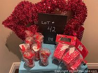 Front view showing assorted Valentine's Day items including red tinsel wreath, glasses, gift bags, and wrapping paper