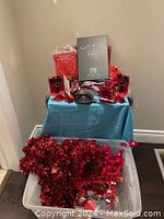 Photo of Valentine-themed assortment displayed on blue table with red tinsel garland in front.