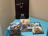 Photo showing X-Men United, X-Men First Class unopened DVDs and X-Men Trilogy DVD set on a surface with lot number board.